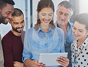 Giving them a sneak preview of her presentation. Cropped shot of a group of businesspeople working in the office.