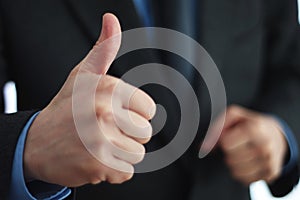 Giving thumbs up sign