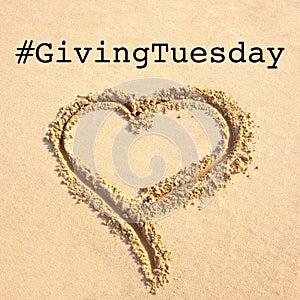 Giving Tuesday concept with heart drawn on sand