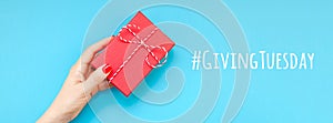 Giving Tuesday concept with red gift box in hand