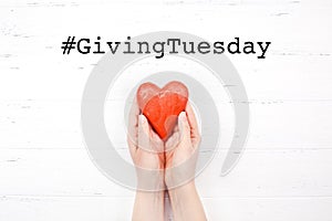 Giving Tuesday concept with red heart in hands