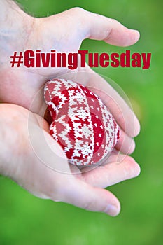 Giving Tuesday concept with red heart in hands