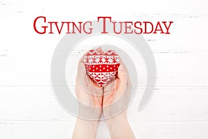 Giving Tuesday concept with red heart in hands