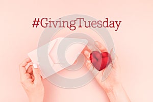 Giving Tuesday concept with red heart in hand