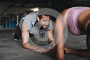 Giving up is never an option. a sporty young couple exercising together inside an underground parking lot.