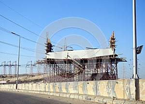 Giza, Egypt, January 7 2024: A construction site of a new bridge that is under construction with a mobile crane and workers, Egypt