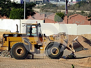 A front loader truck at a construction site of new buildings in Giza Zed city project loaded and transporting sand