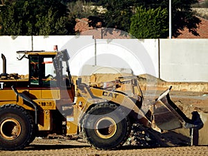 A front loader truck at a construction site of new buildings in Giza Zed city project loaded and transporting sand