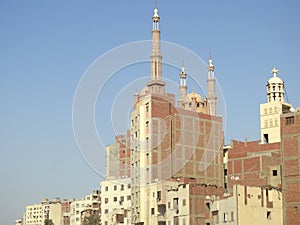 Giza, Egypt, September 28 2023: domes, minarets over a building, a mosque, the minarets and domes over a tall building, beside a