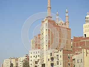 Giza, Egypt, September 28 2023: domes, minarets over a building, a mosque, the minarets and domes over a tall building, beside a