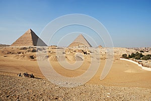 The Giza pyramid complex or Giza Necropolis in Egypt including the Great Cheops Pyramid, the Pyramid of Khafre, and the Pyramid