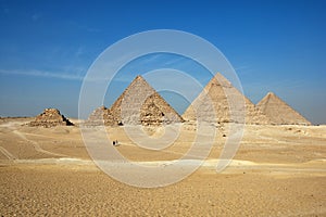 The Giza pyramid complex or Giza Necropolis in Egypt including the Great Cheops Pyramid, the Pyramid of Khafre, and the Pyramid