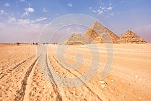 Giza Pyramids and a chariot track through the sand