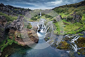 Gjain waterfall flowing in Pjorsardalur lush valley during summer at Iceland