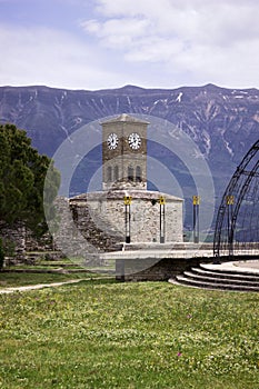 Gjirokastra Castle with a clock, Albania. Albanian fortress against the backdrop of mountains