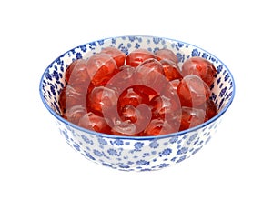 Glace cherries in a blue and white china bowl