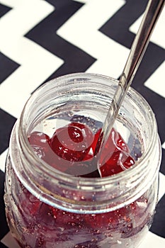 Glace cherries in a vintage jar overhead