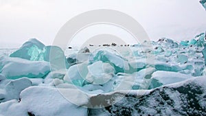 Glacier of beautiful unique turquoise color on background of snow in Arctic.