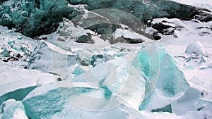 Glacier of beautiful unique turquoise color on background of snow in Arctic.