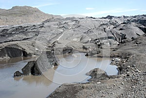 Glacier covered with black volcanic ash - Iceland