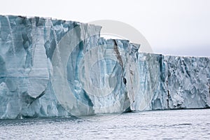 A glacier with floating sea ice north of Svalbard in the Arctic, with water falls