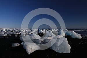 Glacier ice chunks on the black beach at Jokulsarlon, Iceland