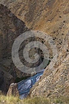 Glacier River flowing through Deep Valley at  kibber village in Spiti Valley,Himachal Pradesh,india,