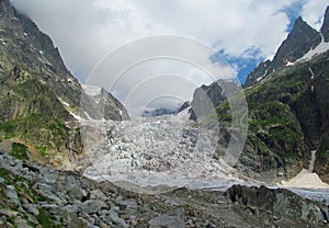 Glacier on Tetnuldi mountain, rocky peaks with snow in Svanetia Caucasian mountains in Georgia