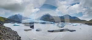 Glacier tongue slides from the Vatnajokull icecap or Vatna Glacier near subglacial Oaefajokull volcano, Iceland. Glacial lagoon