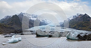 Glacier tongue slides from the Vatnajokull icecap or Vatna Glacier near subglacial Oraefajokull volcano, Iceland. Glacial lagoon