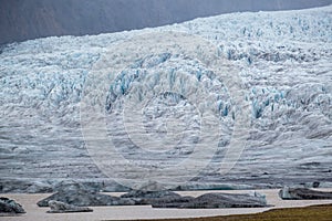 Glacier tongue slides from VatnajÃ¶kull icecap or Vatna Glacier near subglacial Ã–rÃ¦fajÃ¶kull volcano, Iceland. Glacial lagoon