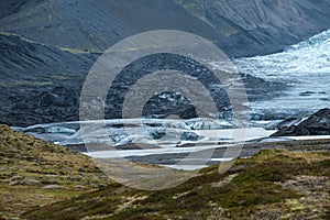 Glacier tongue slides from VatnajÃ¶kull icecap or Vatna Glacier near subglacial Ã–rÃ¦fajÃ¶kull volcano, Iceland. Glacial lagoon