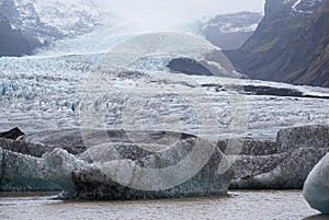 Glacier tongue slides from VatnajÃ¶kull icecap or Vatna Glacier near subglacial Ã–rÃ¦fajÃ¶kull volcano, Iceland. Glacial lagoon
