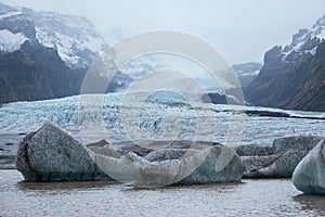 Glacier tongue slides from VatnajÃ¶kull icecap or Vatna Glacier near subglacial Ã–rÃ¦fajÃ¶kull volcano, Iceland. Glacial lagoon