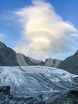 Glacier view. Amazing cloud in the Belukha Mountain area. Altai, Russia