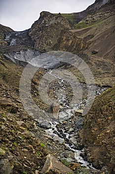 The glaciers covered by the old volcanic rock descend to the edge of Shimshal village, bringing with them the water