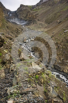 The glaciers covered by the old volcanic rock descend to the edge of Shimshal village, bringing with them the water