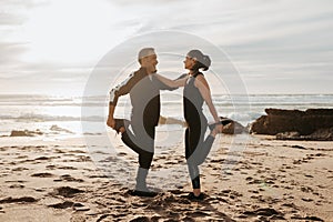 Glad active mature european man and woman doing leg exercises, stretching and warm up for run