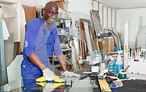 Glad African American glazier during daily work