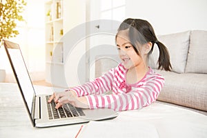 Glad asian schoolgirl with her computer