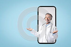 Glad caucasian mature man doctor in white coat, headphones spreads arms to sides, hold free space