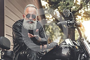 Glad elder male person using motorbike