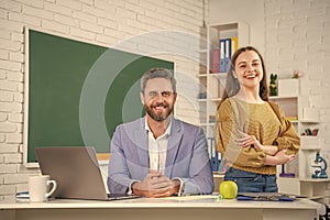 glad girl with man teacher in classroom. education photo