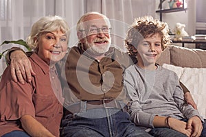 Glad grandparents and happy grandson