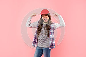 glad kid with curly hair in cap. teen hipster beauty hairstyle. female casual fashion model.