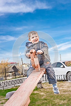 ÃÂ glad little boy on a teetertotter