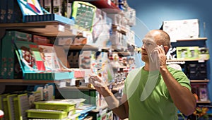 Glad man in front of difficult choice in store photo