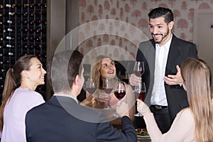 Glad man pronouncing toast in cozy restaurant