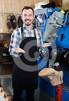 Glad man worker displaying his workplace