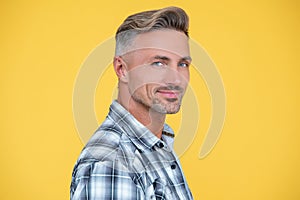 glad mature man with grizzle hair on yellow background